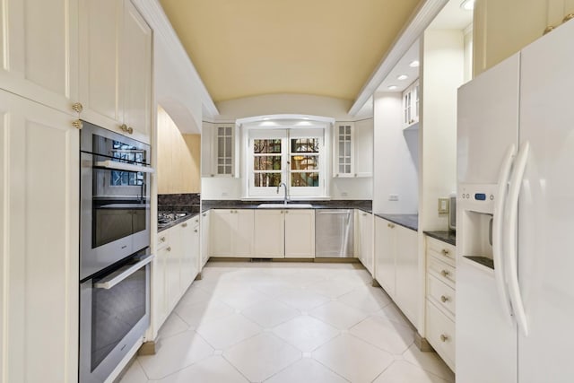 1355 N Astor St, Chicago, IL 60610 - kitchen featuring white refrigerator with ice dispenser, a sink, dark countertops, and double oven