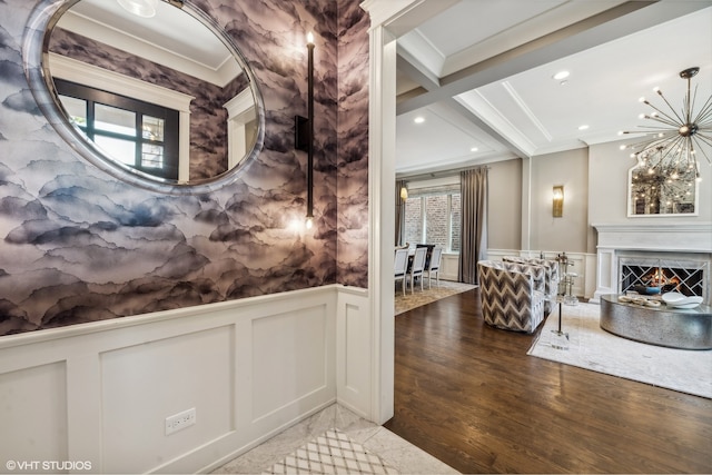 hallway with hardwood / wood-style floors, an inviting chandelier, beamed ceiling, crown molding, and coffered ceiling