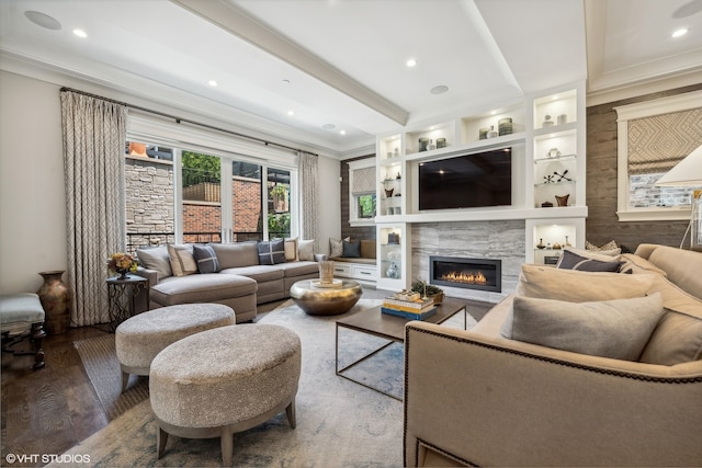 living room with crown molding, hardwood / wood-style flooring, and a fireplace