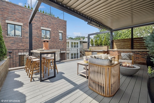 wooden terrace featuring an outdoor living space with a fire pit