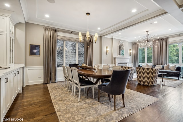 dining room featuring ornamental molding, dark hardwood / wood-style flooring, and an inviting chandelier