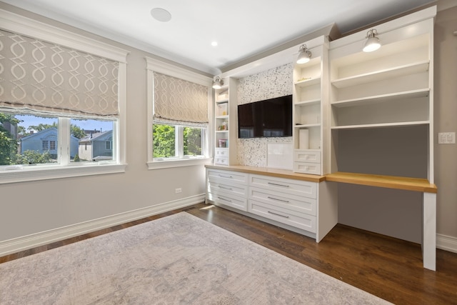 unfurnished bedroom with dark wood-type flooring