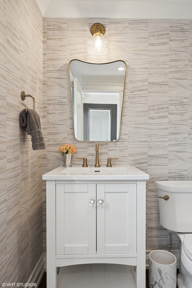 bathroom featuring tile walls, vanity, and toilet