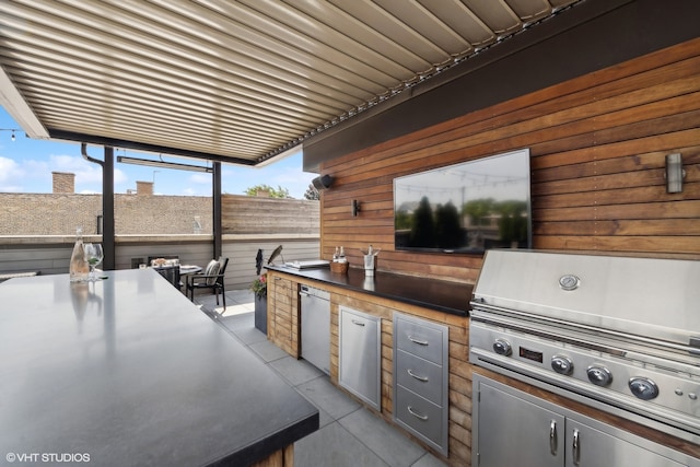 view of patio / terrace featuring a grill and an outdoor kitchen