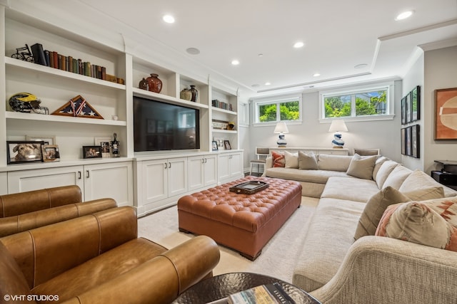 living room with crown molding and built in shelves