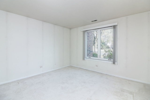 unfurnished room with baseboards, visible vents, and carpet flooring