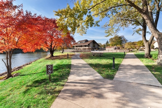 view of home's community with a yard and a water view