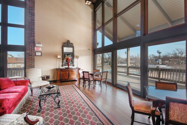 sunroom with a healthy amount of sunlight and beamed ceiling