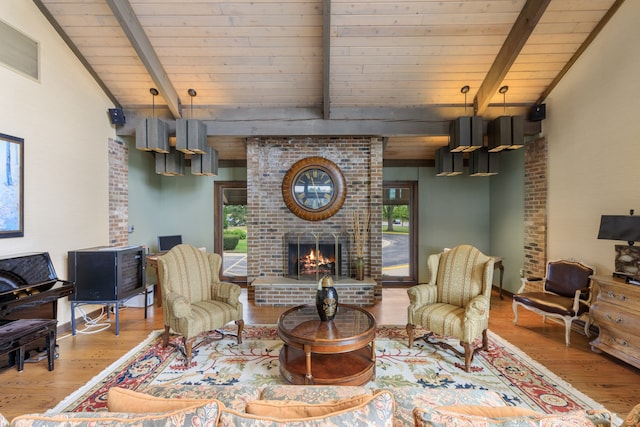 living area featuring a brick fireplace, a wealth of natural light, and wood finished floors