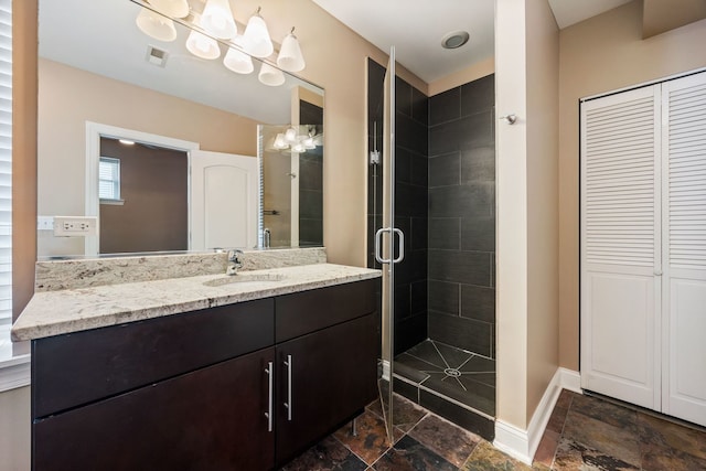 bathroom with vanity and a shower with door