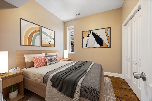 bedroom with a closet and dark wood-type flooring