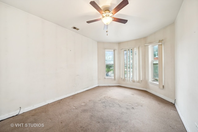 spare room featuring ceiling fan and carpet