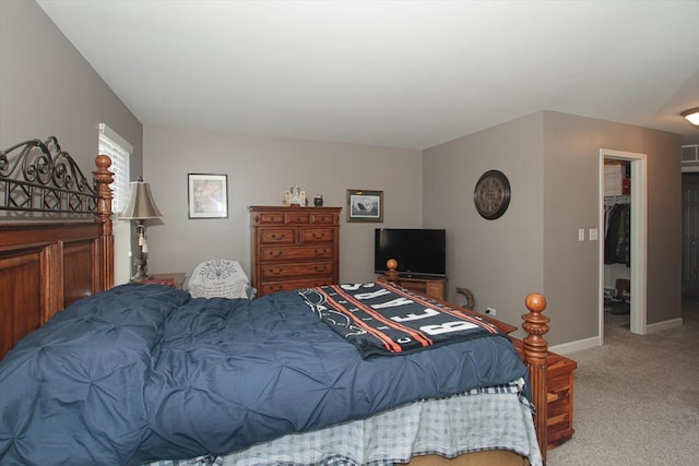 bedroom featuring a spacious closet, carpet flooring, and a closet