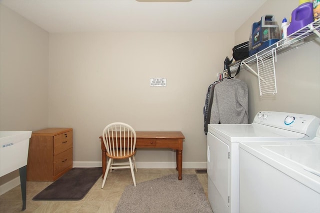 clothes washing area featuring washer and dryer and light tile patterned floors