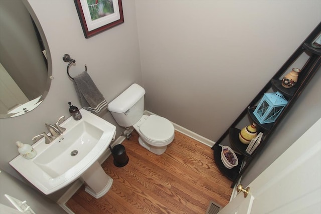 bathroom featuring sink, wood-type flooring, and toilet