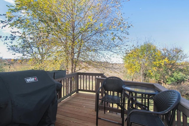 wooden deck featuring a grill