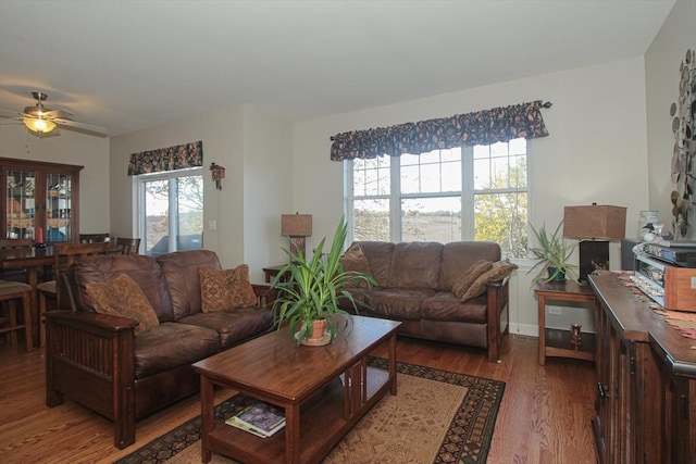 living room featuring dark hardwood / wood-style floors and ceiling fan