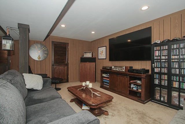 carpeted living room with wooden walls