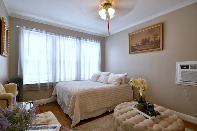 bedroom featuring ceiling fan, multiple windows, and light wood-type flooring