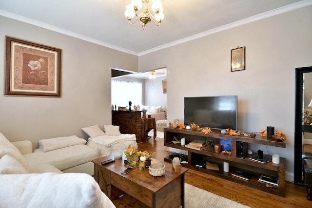 living room featuring ornamental molding, ceiling fan with notable chandelier, and hardwood / wood-style floors