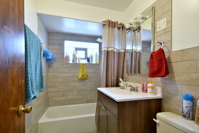 full bathroom featuring tile walls, vanity, shower / bath combo, and toilet