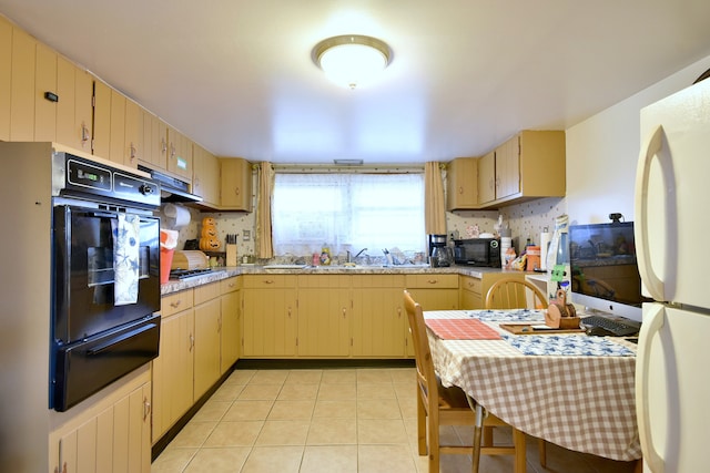 kitchen featuring light brown cabinetry, black appliances, backsplash, extractor fan, and light tile patterned floors