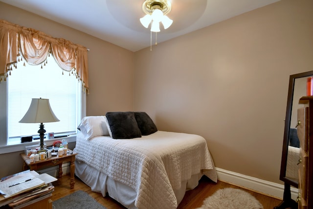 bedroom featuring dark hardwood / wood-style floors and ceiling fan