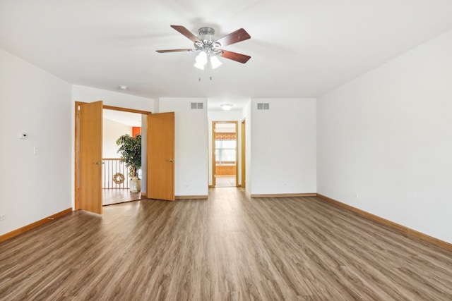 unfurnished room with hardwood / wood-style floors and ceiling fan