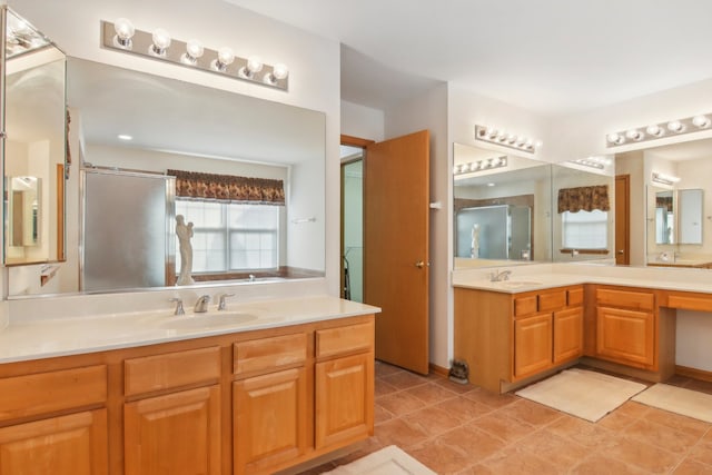 bathroom with vanity, tile patterned floors, and a shower with door