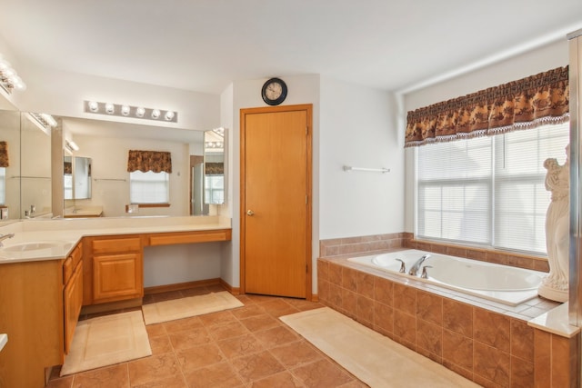 bathroom featuring vanity, tiled tub, and tile patterned flooring