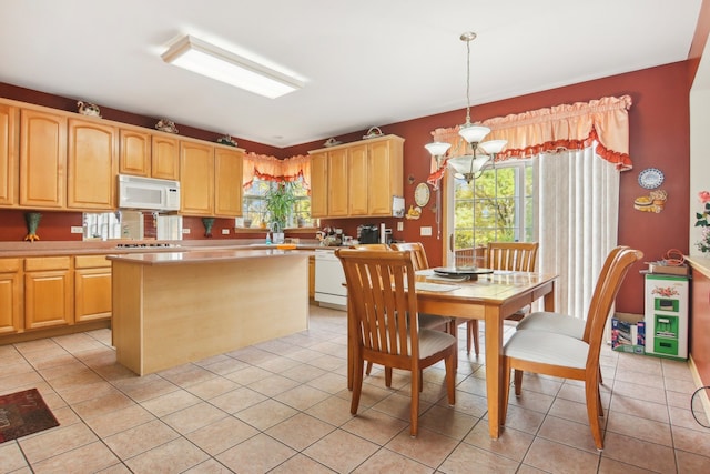 kitchen with white appliances, decorative light fixtures, light tile patterned floors, light brown cabinets, and an inviting chandelier