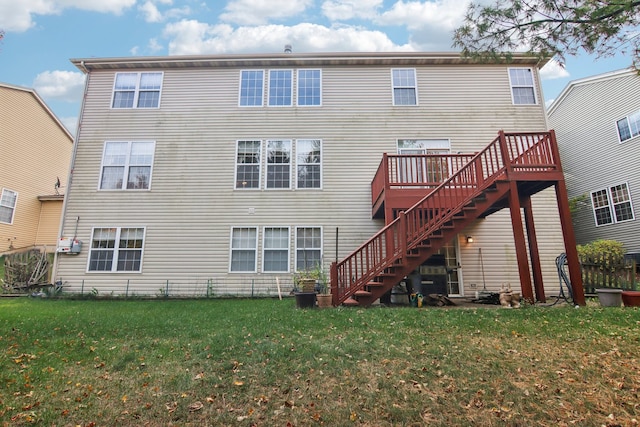 back of house with a wooden deck and a yard