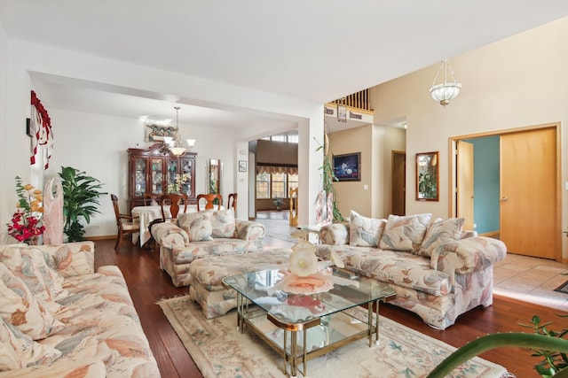 living room featuring an inviting chandelier and wood-type flooring