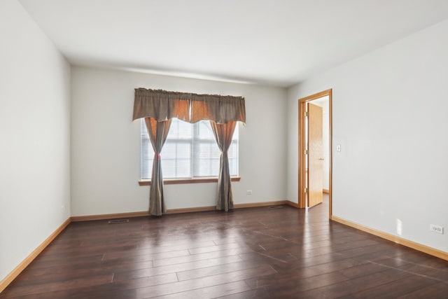 spare room with dark wood-type flooring