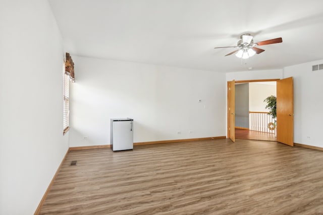 unfurnished room with hardwood / wood-style flooring and ceiling fan