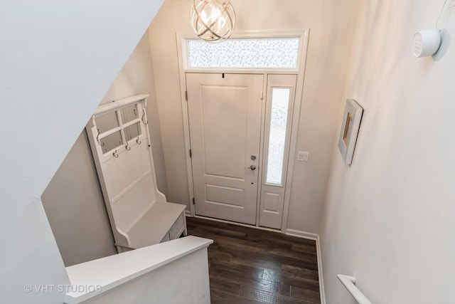 entrance foyer featuring dark hardwood / wood-style floors and an inviting chandelier