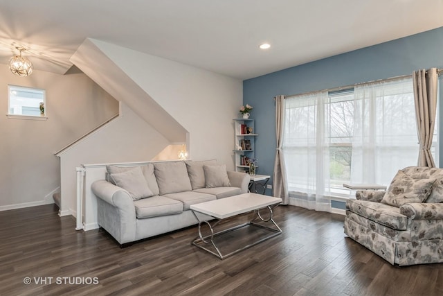 living room featuring dark hardwood / wood-style flooring and a healthy amount of sunlight