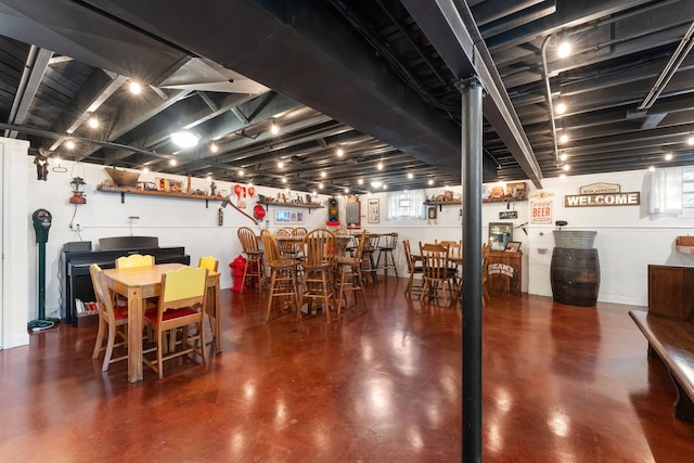 basement with bar and a wealth of natural light