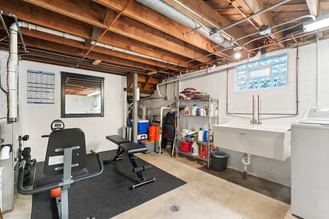 workout area featuring washer / dryer and sink