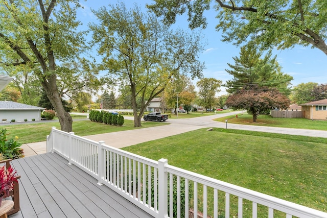 wooden deck featuring a lawn