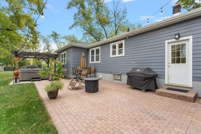 view of patio / terrace with a pergola, a hot tub, and a grill