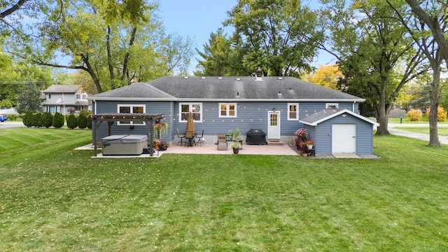 rear view of property featuring a patio area, a lawn, and an outbuilding