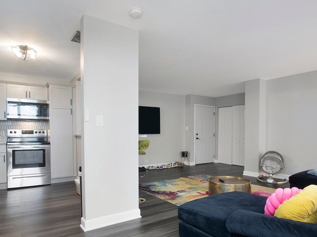 living room with dark hardwood / wood-style flooring