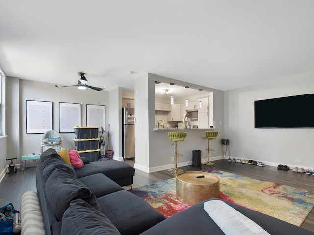 living room with dark wood-type flooring and ceiling fan