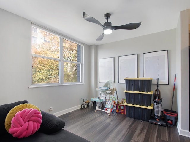 recreation room featuring dark wood-type flooring and ceiling fan