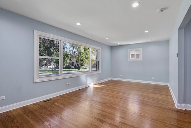 unfurnished room with hardwood / wood-style floors