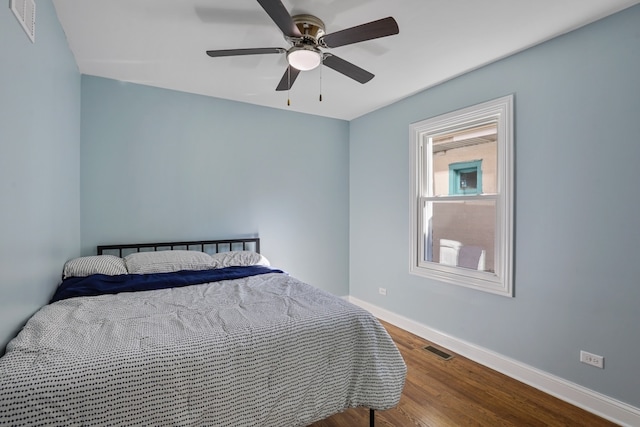 bedroom with hardwood / wood-style flooring and ceiling fan