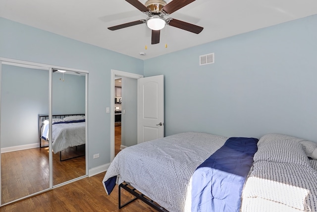 bedroom featuring hardwood / wood-style floors, a closet, and ceiling fan