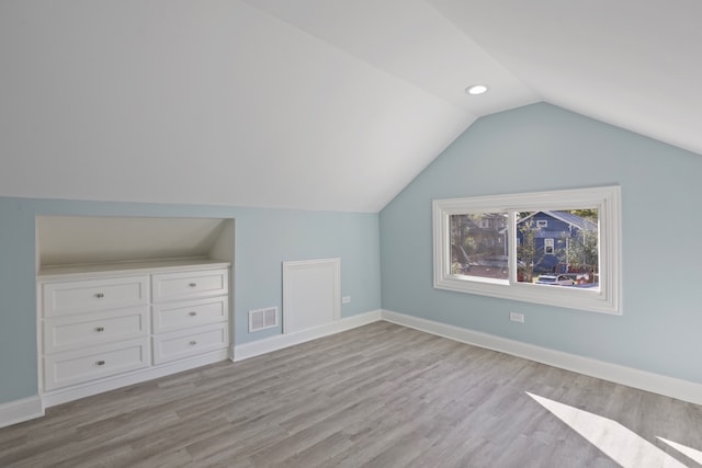 bonus room featuring light hardwood / wood-style floors and vaulted ceiling