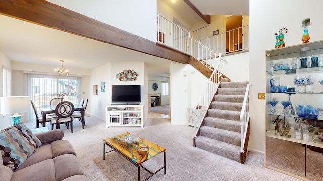 carpeted living room featuring beamed ceiling, a chandelier, and a high ceiling